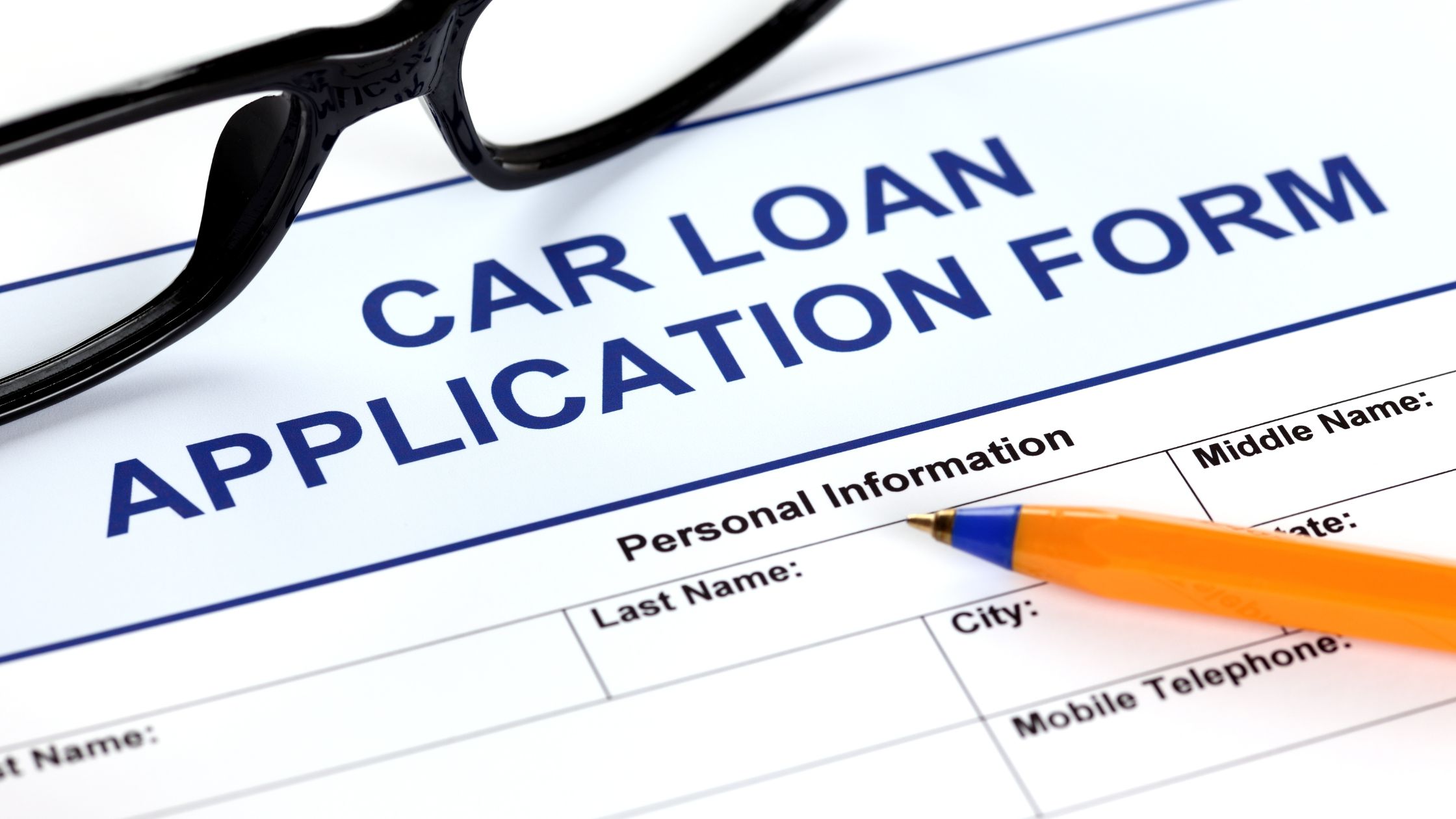 car loan application paper with pen on top