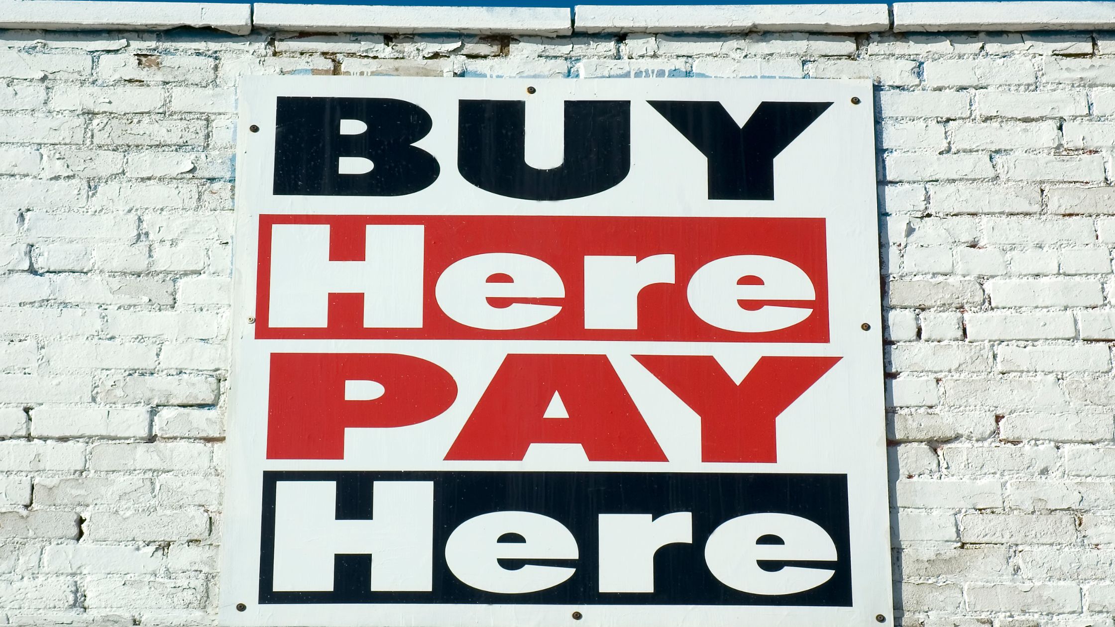 white sign saying buy here pay here