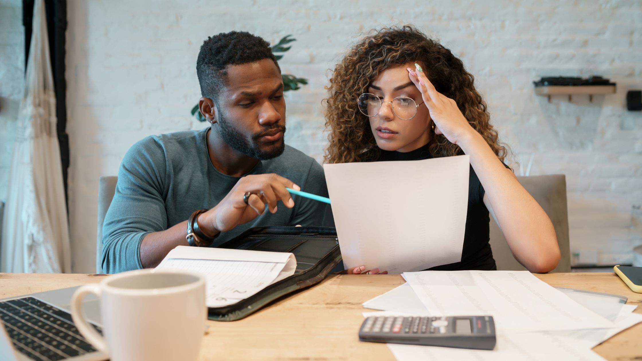 black man and woman reviewing loan paperwork