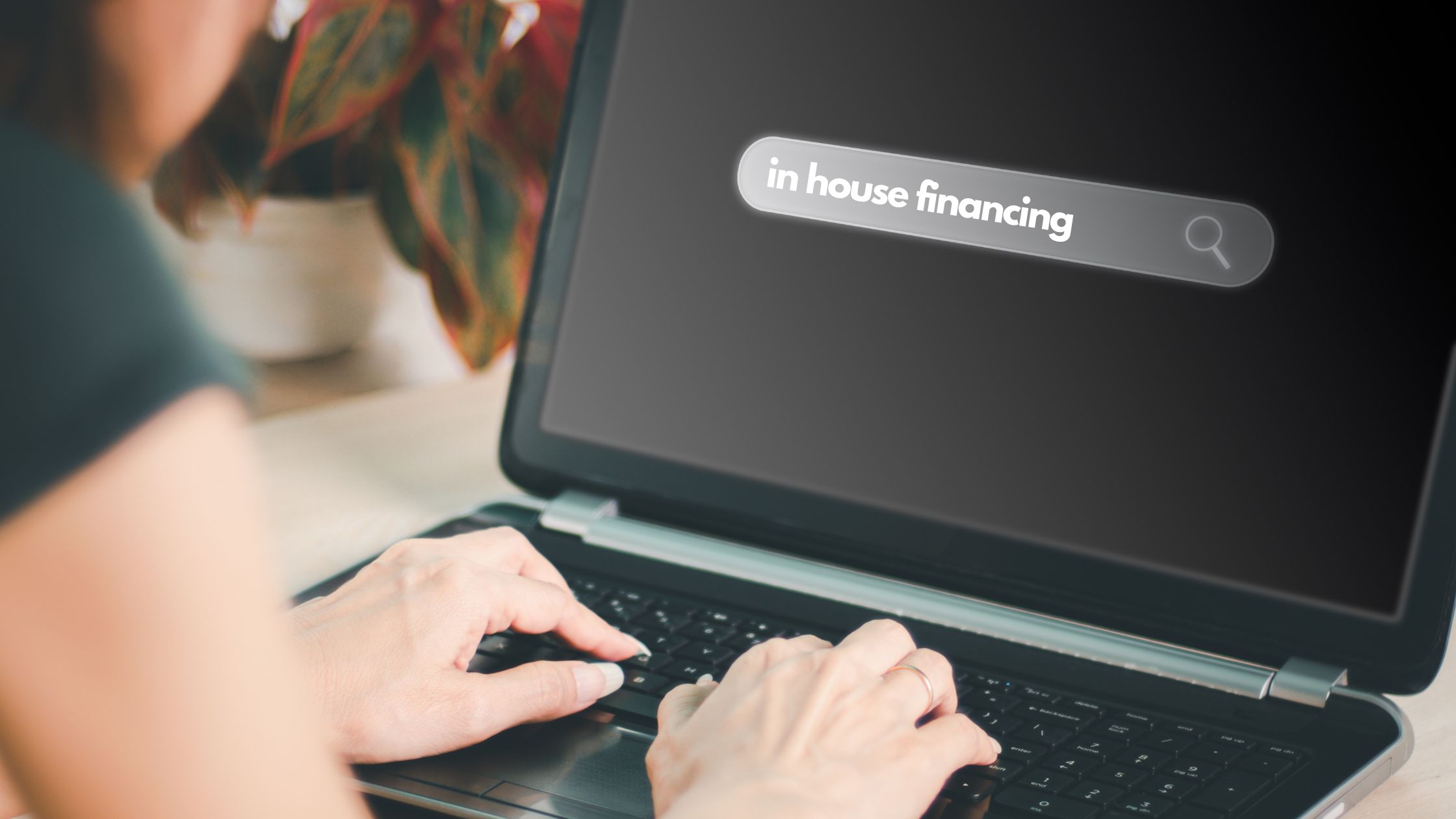 person typing in house financing on computer