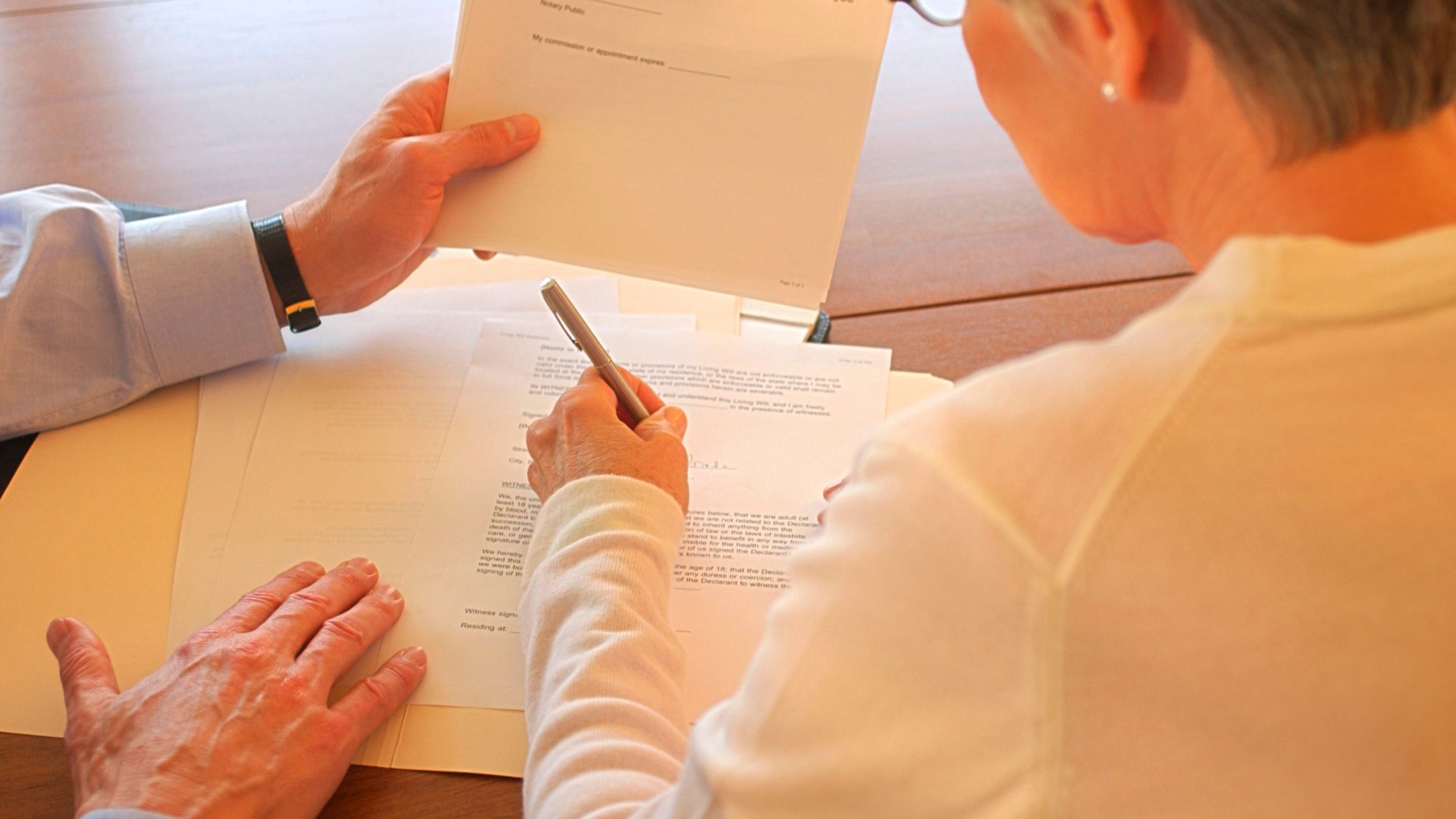 woman signing paperwork